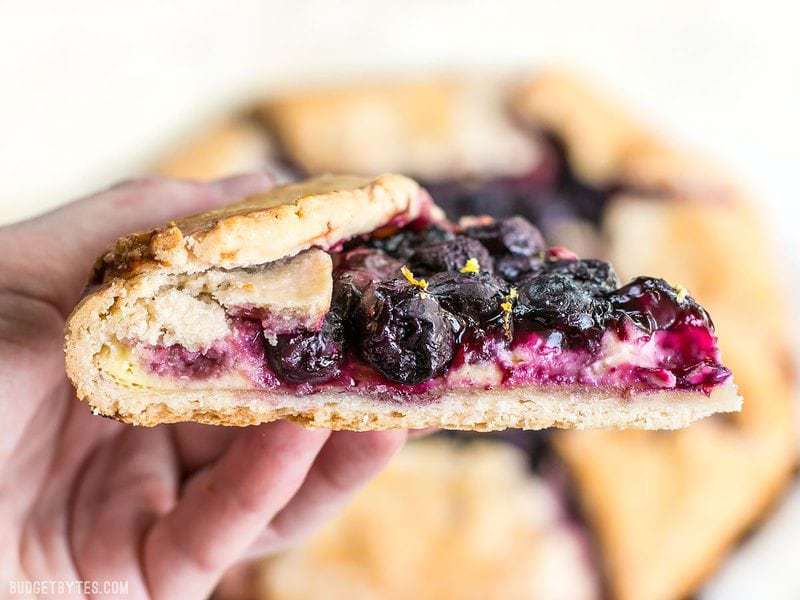 Close up side view of a slice of Lemon Blueberry Cream Cheese Galette.