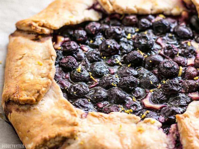 Close view of the baked blueberries on top of Lemon Blueberry Cream Cheese Galette.