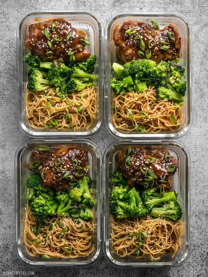 Four glass Sticky Ginger Soy Glazed Chicken Meal Prep containers side by side