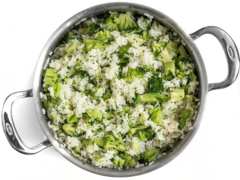 Chopped broccoli folded into rice