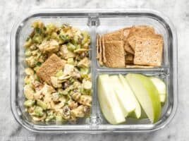 Curry Chicken Salad is paired with crunchy crackers for dipping and a tart apple to cleanse the palate in this simple cold lunch box. BudgetBytes.com