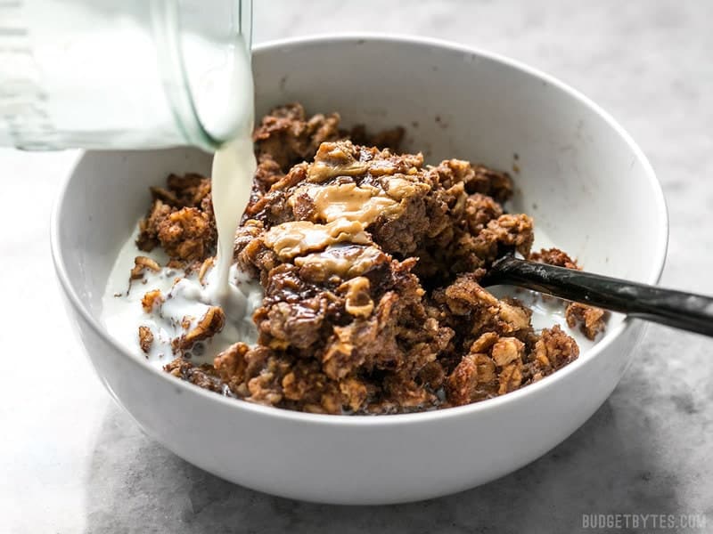 Milk being poured onto a bowl of Peanut Butter Brownie Baked Oatmeal 