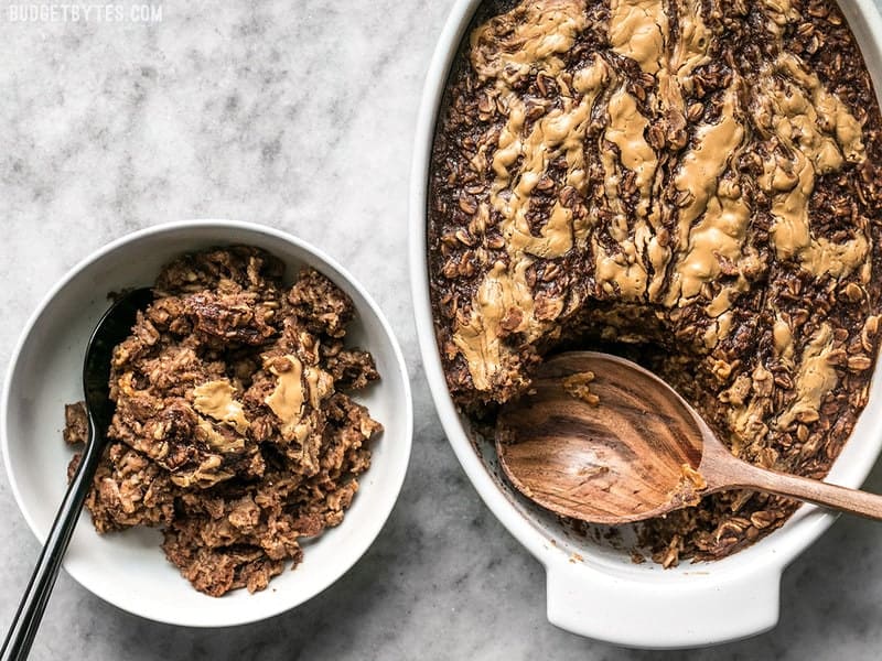 Peanut Butter Brownie Baked Oatmeal being served into a bowl from the casserole dish