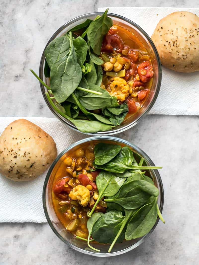 This Moroccan Lentil and Vegetable Stew is full of warm spices, paired with homemade rolls and pumped up with an extra handful of spinach for an absolutely killer meal. BudgetBytes.com