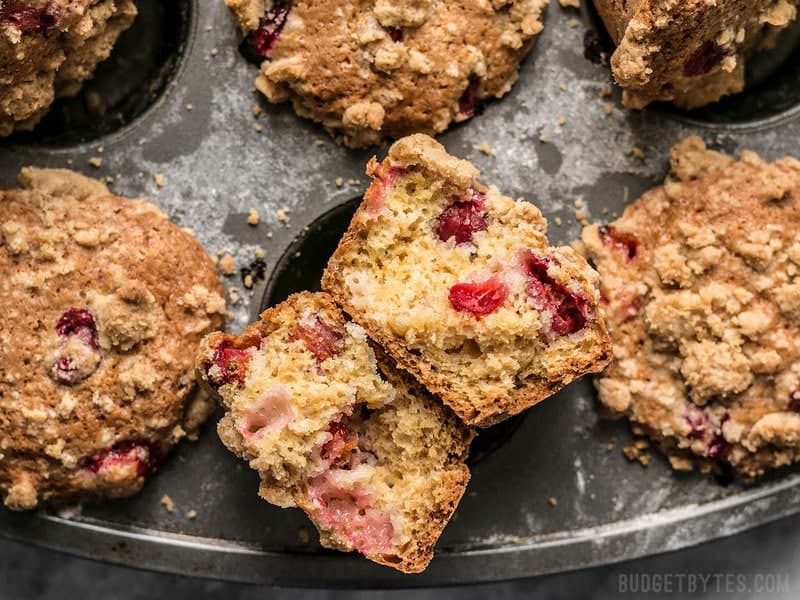 Close up of Orange Cranberry Muffins with one torn in half. 