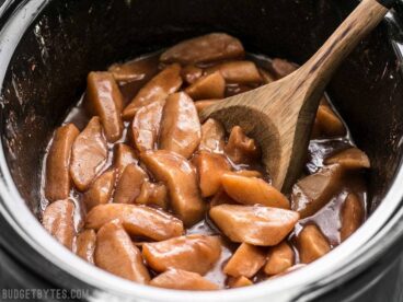 Slow Cooker Hot Buttered Apples are an easy and versatile dessert that is perfect for using up your glut of autumn apples! BudgetBytes.com