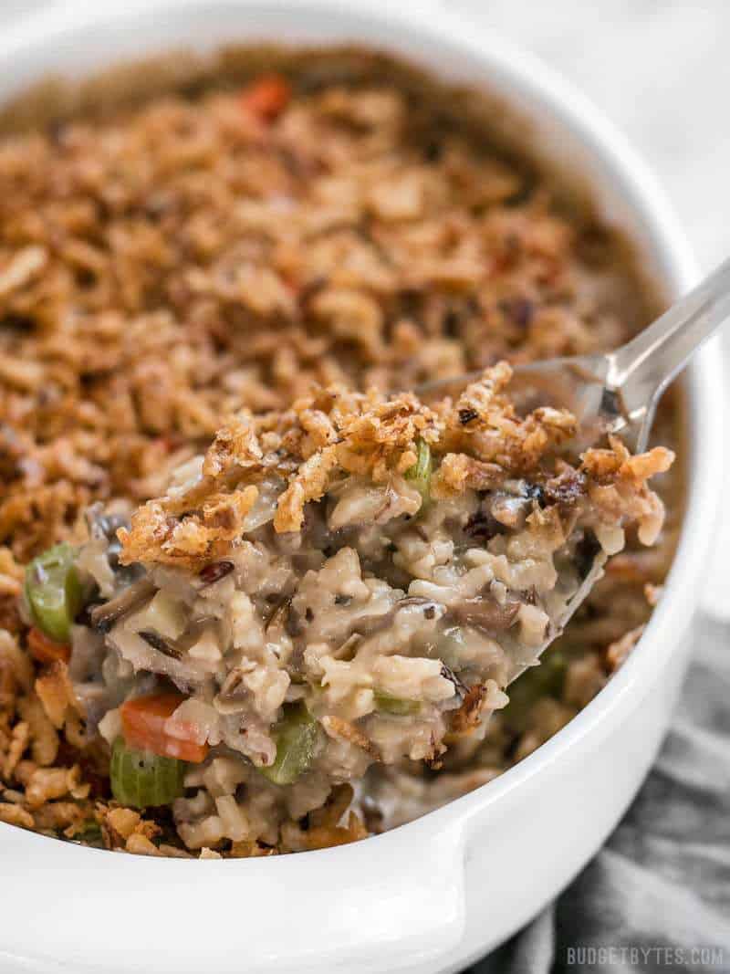 Close up view of Wild Rice and Vegetable Casserole being scooped out of a dish.