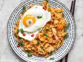 This Kimchi Fried rice is tangy, spicy, and the perfect way to use up all the leftover ingredients and scraps in your kitchen. BudgetBytes.com