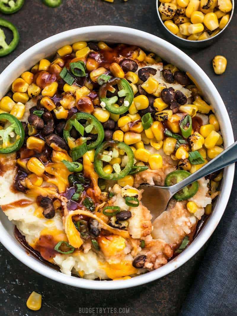 A fork digging into the Loaded Mashed Potato Bowls