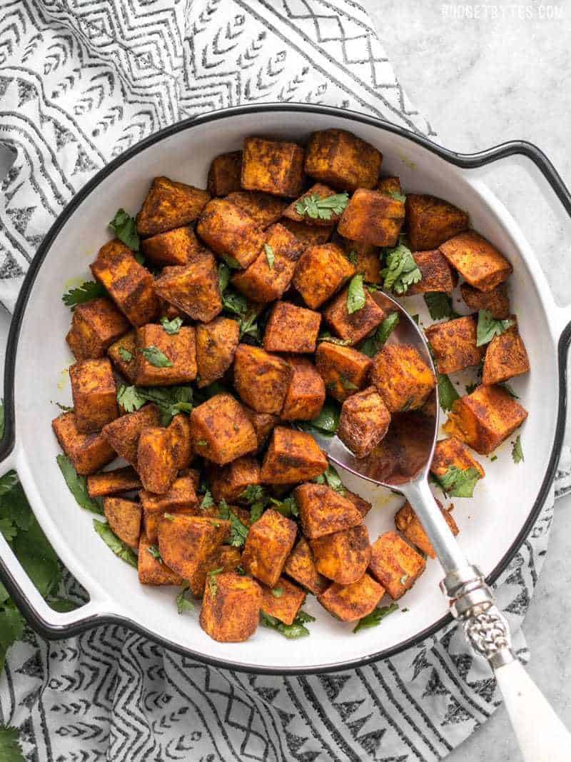 Finished Moroccan Spiced Sweet Potatoes in a serving dish with cilantro