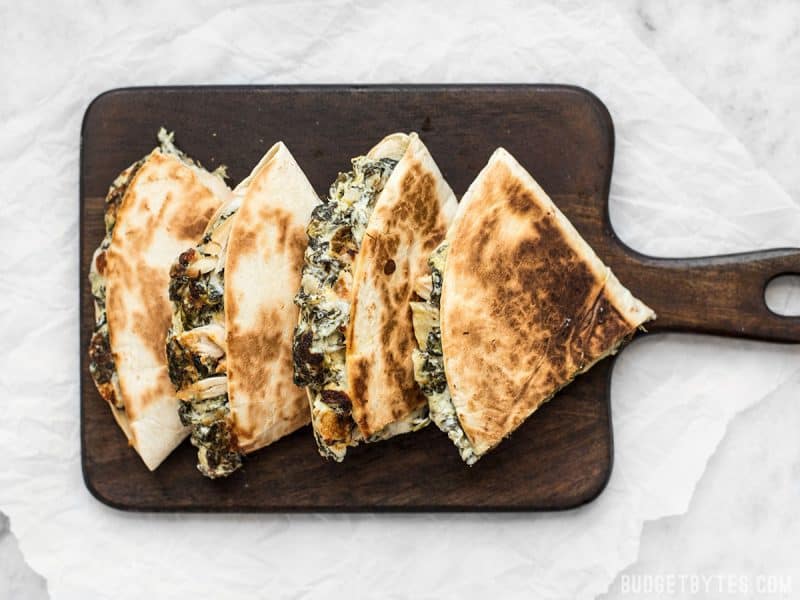 Overhead view of Spinach Artichoke Quesadillas on a cutting board