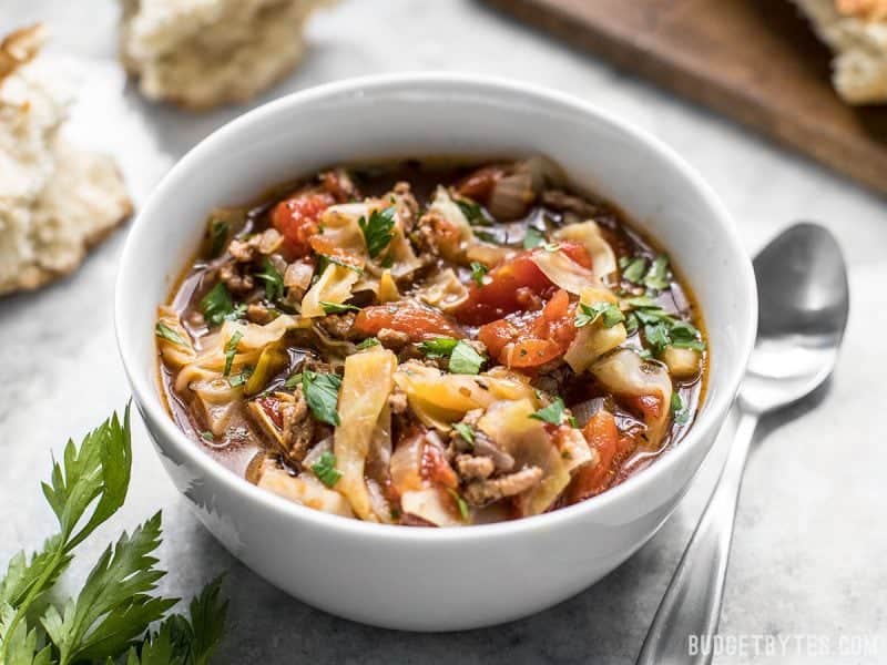 Front view of a bowl of Beef and Cabbage Soup with parsley on top