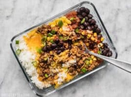 The Easiest Burrito Bowl Meal Prep that you can put together in about 30 minutes with minimal cooking, chopping, and nothing to pack on the side. Lunch can be easy and tasty! BudgetBytes.com