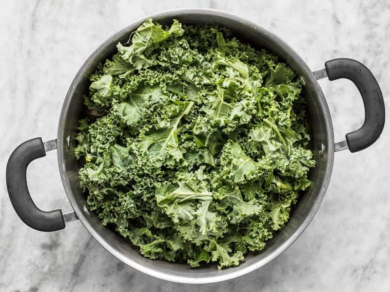 Fresh kale added to a large pot