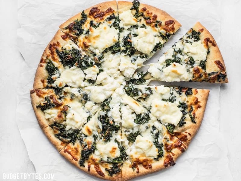 Sliced Kale Pizza on parchment paper