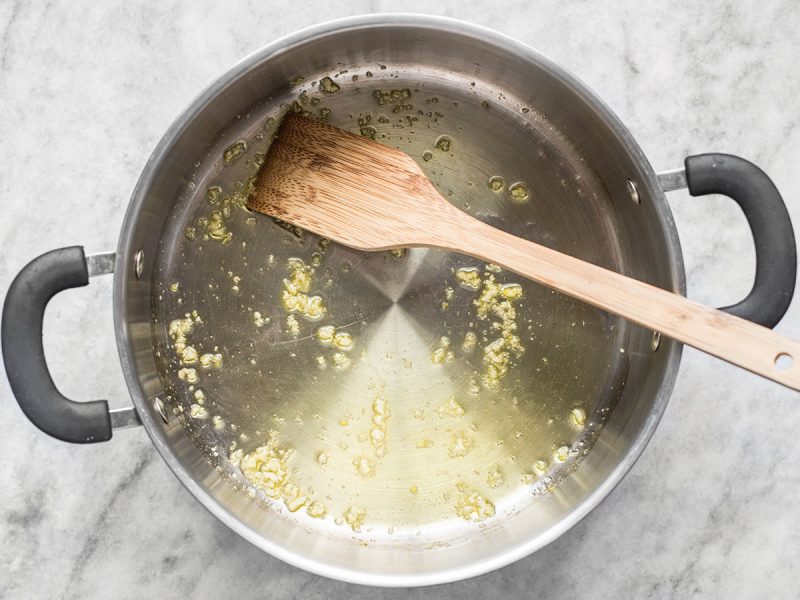 Sautéed Garlic in a pot with a wooden spoon