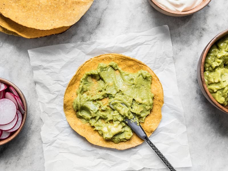 Smear Guacamole on Tostada Shell