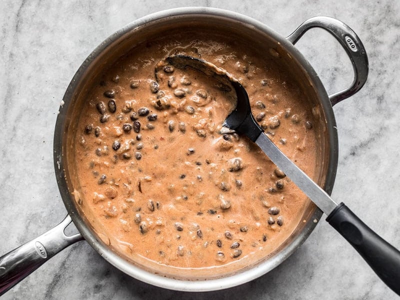 Combine tempered sour cream with salsa in skillet