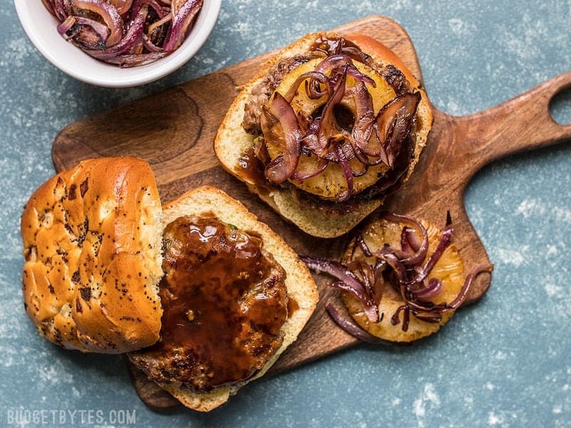 Finished Hawaiian Burgers on a wooden cutting board