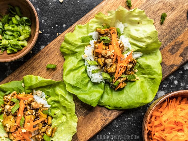 Close up of Hoisin Tofu Lettuce Cups arranged on a wooden cutting board