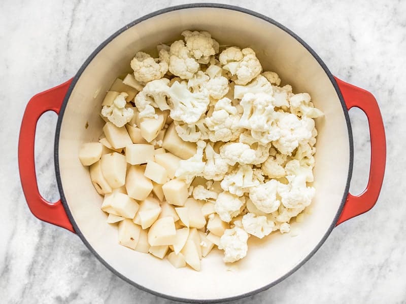 Add diced potatoes and cauliflower florets to soup pot