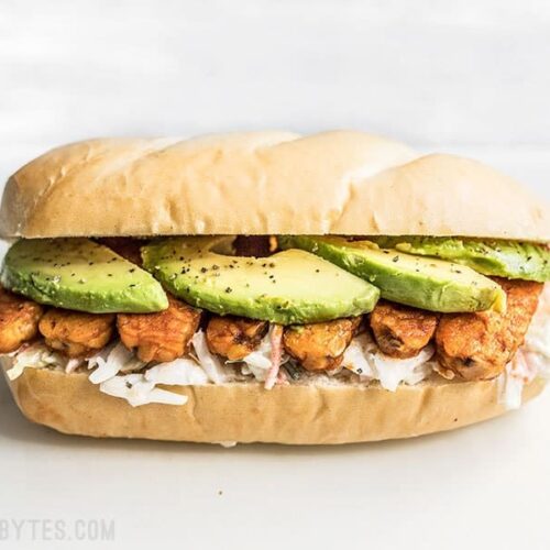 Buffalo Tempeh Sandwich on a Cutting Board