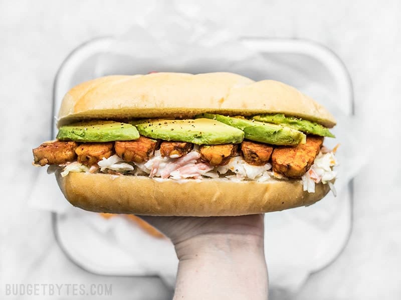 Buffalo Tempeh Sandwich in hand