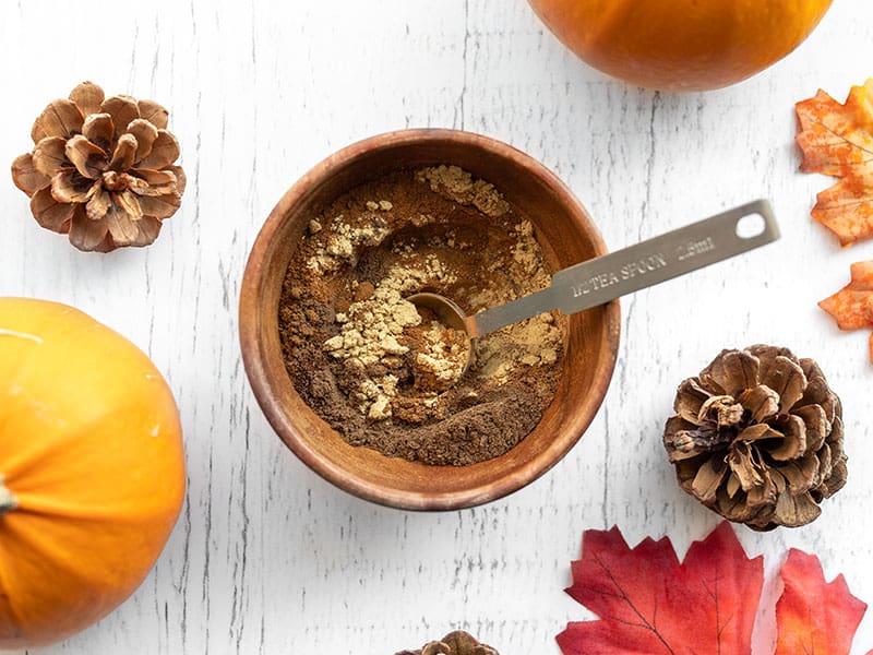 spices in a wooden bowl half stirred