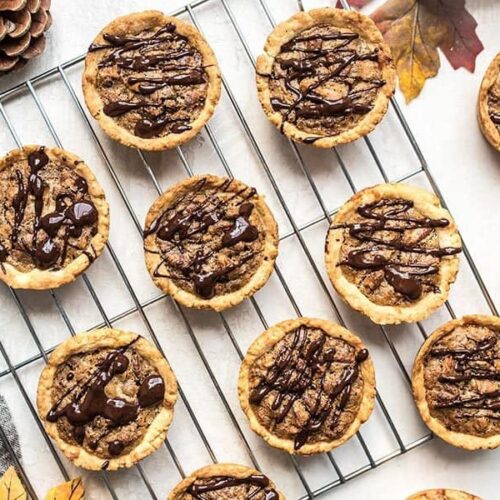 These easy Mini Pecan Pies studded with dark chocolate make the perfectly balanced and pre-portioned dessert for all of your holiday gatherings. Budgetbytes.com