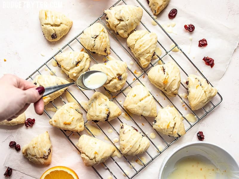 Cranberry Orange Cream Scones being glazed.