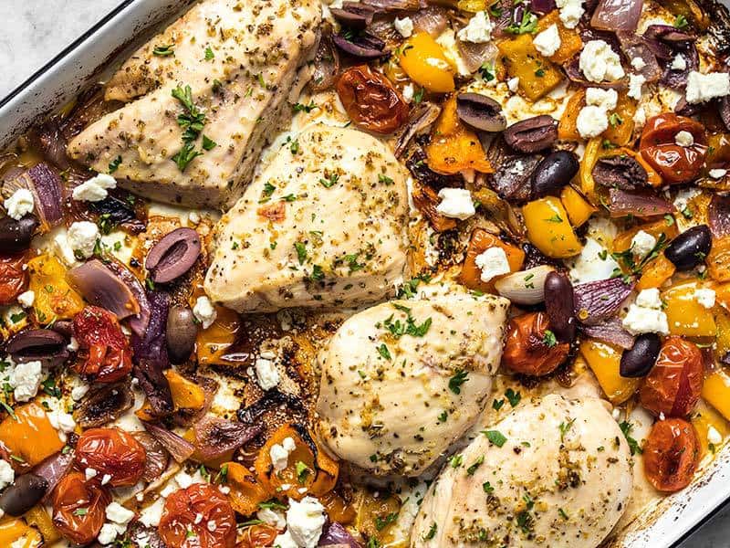 Add olives, parsley, and lemon zest to Sheet Pan Greek Chicken and Vegetables