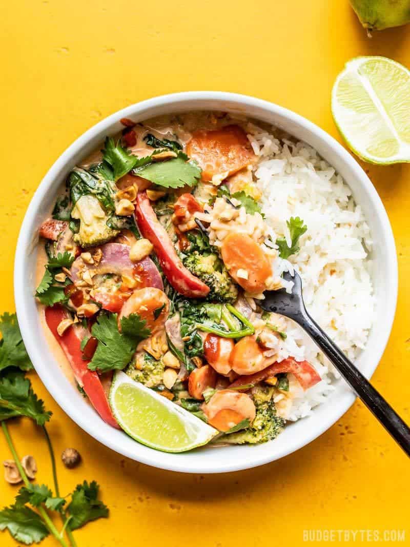 Big bowl of Spicy Coconut Vegetable Stir Fry with lime wedge