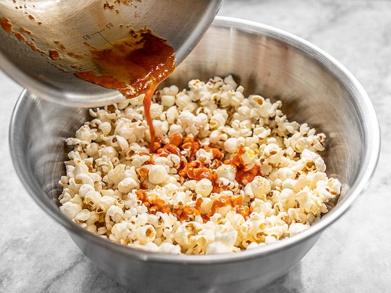 Drizzle sriracha butter over popcorn