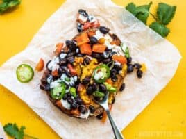 One Loaded Sweet Potato being eaten with a fork.