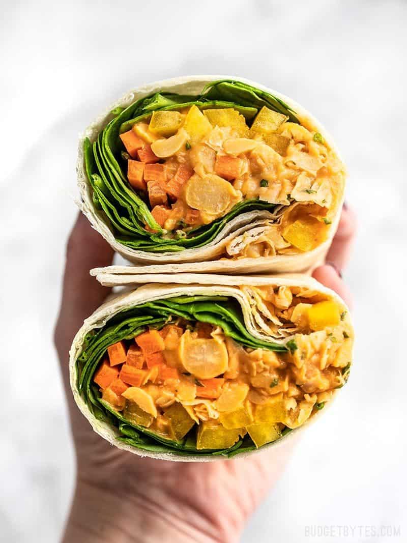 A Sriracha Chickpea Salad Wrap cut open, with open sides facing viewer.