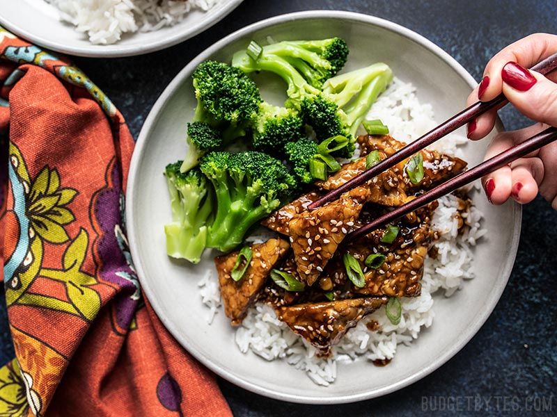 Sesame Tempeh Bowls being eaten with chopsticks