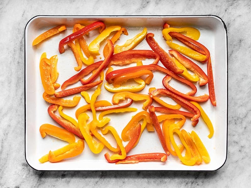 Sliced Bell Peppers on baking sheet, coated in oil