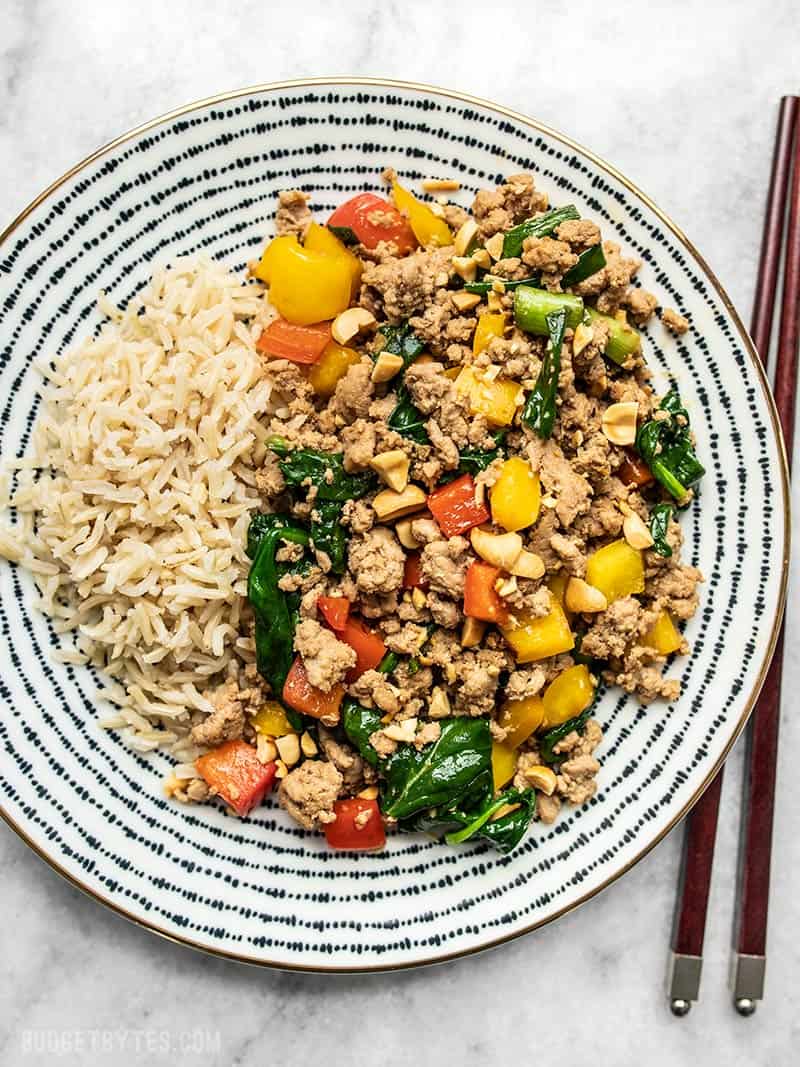 A patterned plate full of Ground Turkey Stir Fry and brown rice.