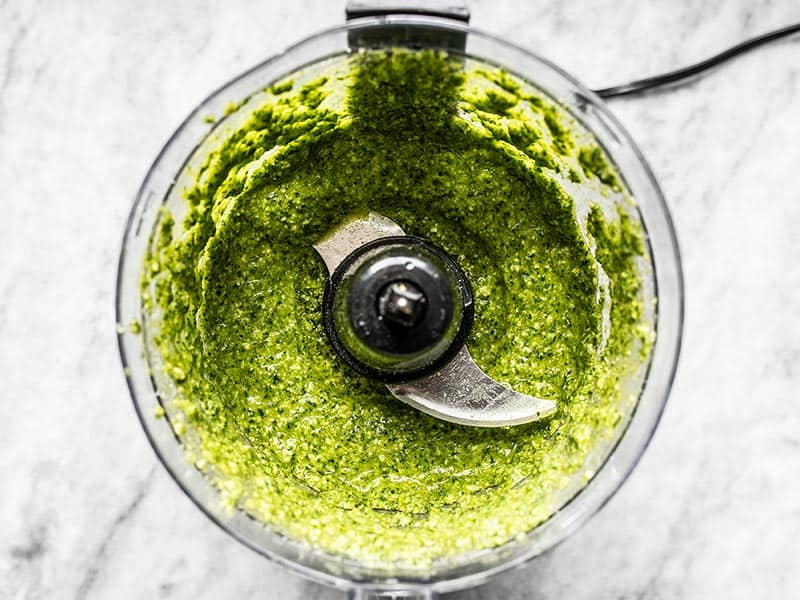 Processed parsley pesto pasta with oil in the food processor