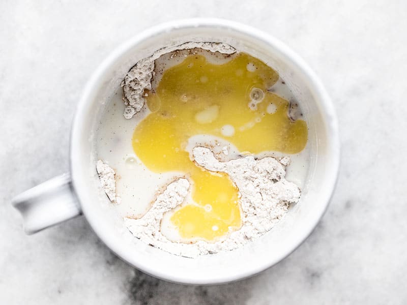 Add butter and milk to mug cake batter dry ingredients