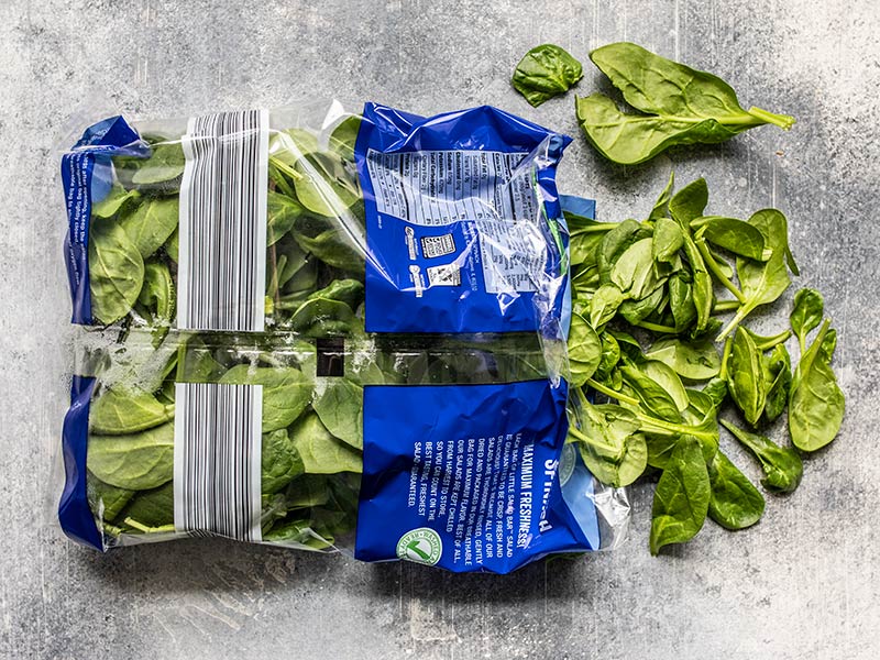 Fresh spinach spilling out of the bag