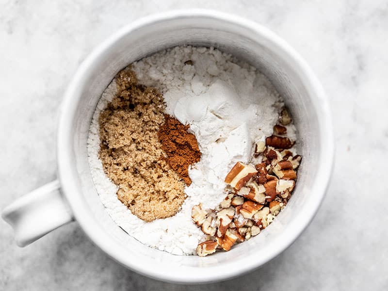 Dry ingredients for cinnamon nut swirl mug cake in a mug