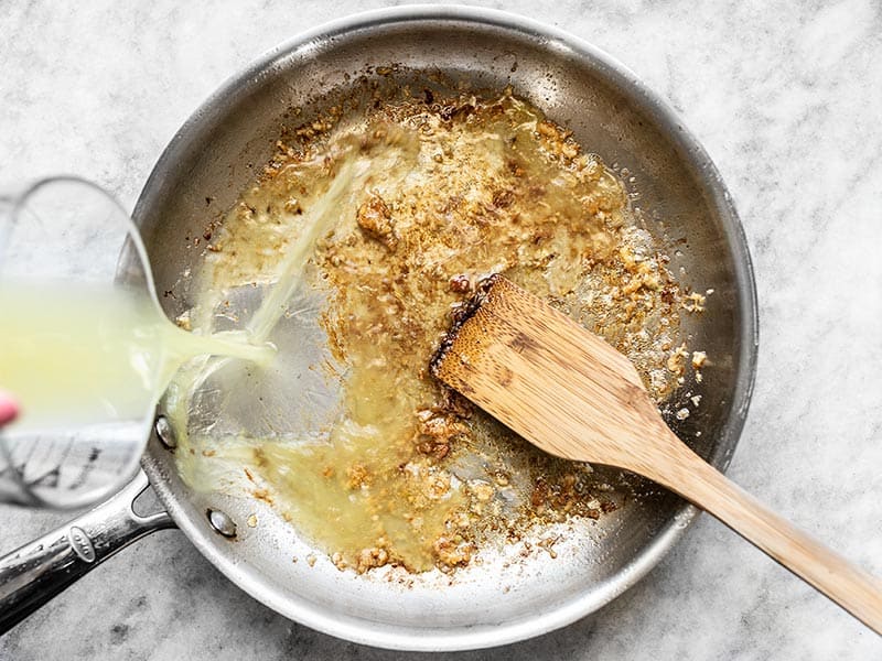 Deglaze skillet with chicken broth