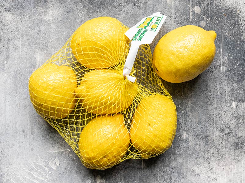 Fresh lemons in a mesh bag