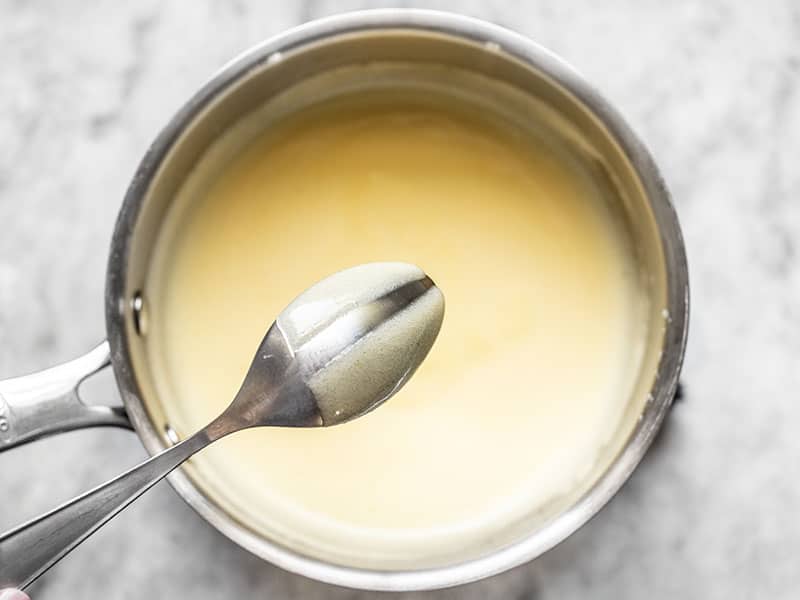 Thickened sugar egg and lemon mixture, coating the back of a spoon.