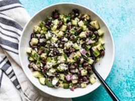 Cucumber and Black Bean Salad in a bowl with a black spoon