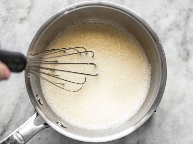 Half cooked sugar egg and lemon juice in the pot, very frothy from continuous whisking.