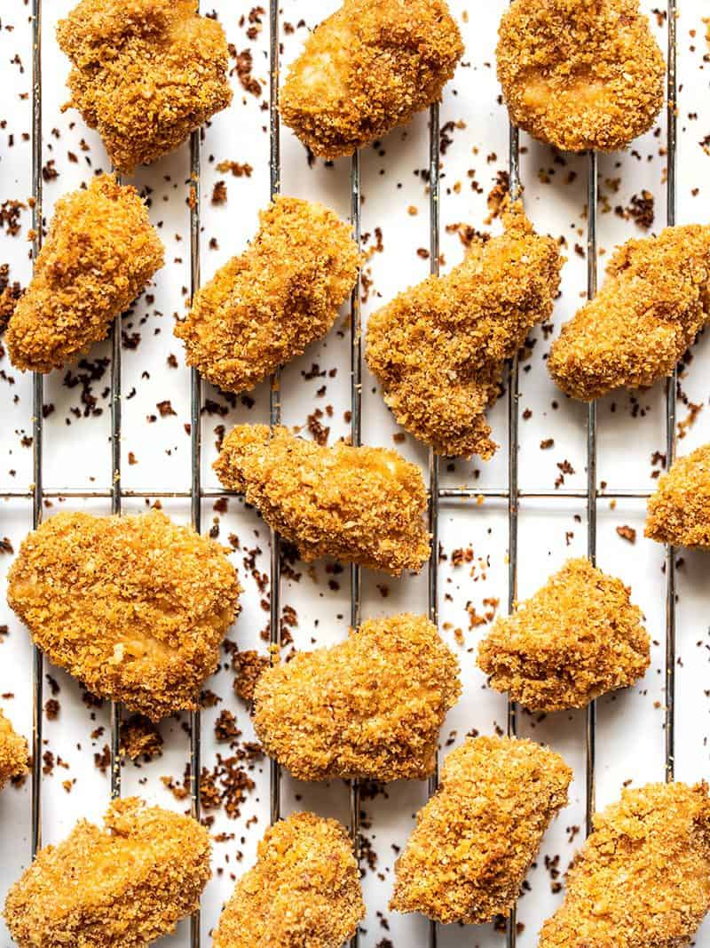 Homemade Baked Chicken Nuggets on a wire cooling rack, close up. 