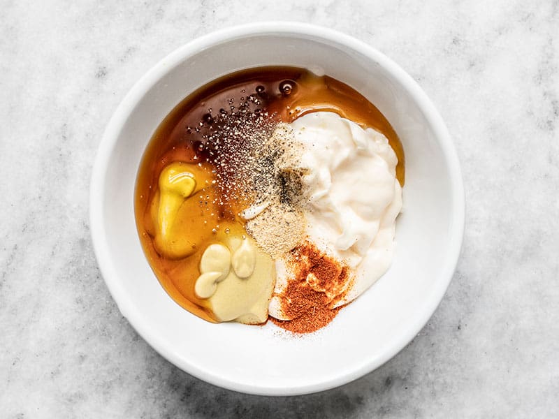 Ingredients for honey mustard sauce in a bowl