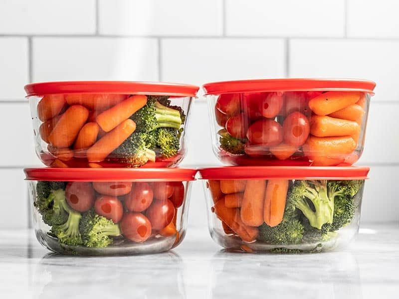 Closed containers full of veggie snack packs, stacked in sets of two